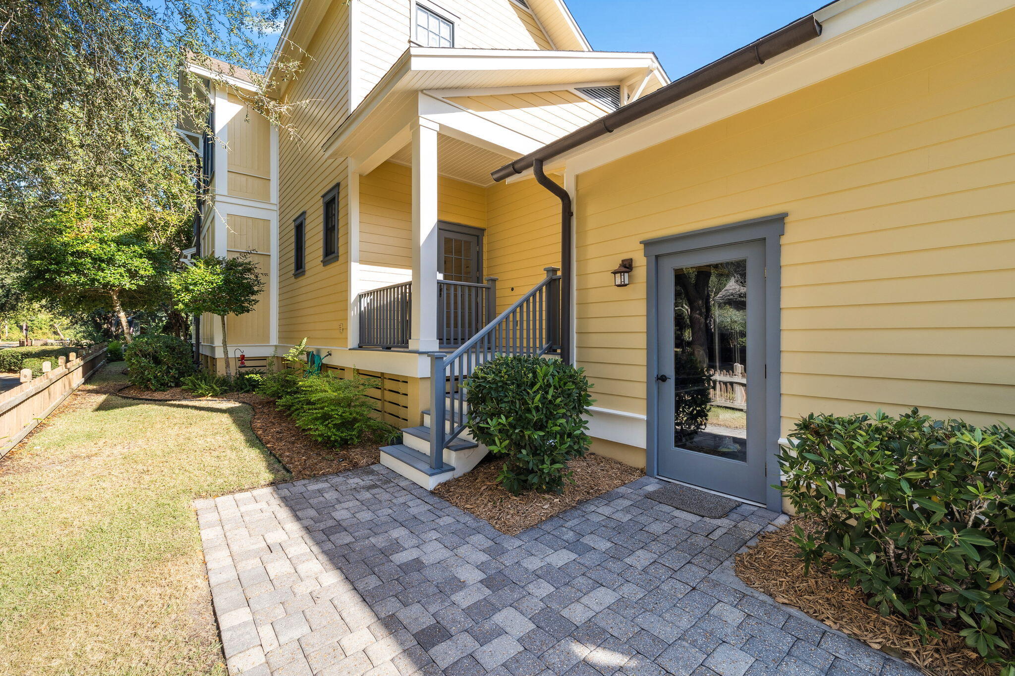 1237 Prospect Promenade Panama City Beach, FL 32413 - Photo 36 of 50 a front view of a house with garden