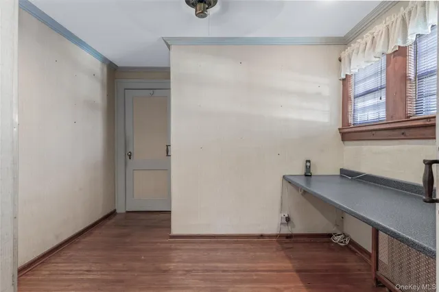 a view of a room with wooden floor and fan