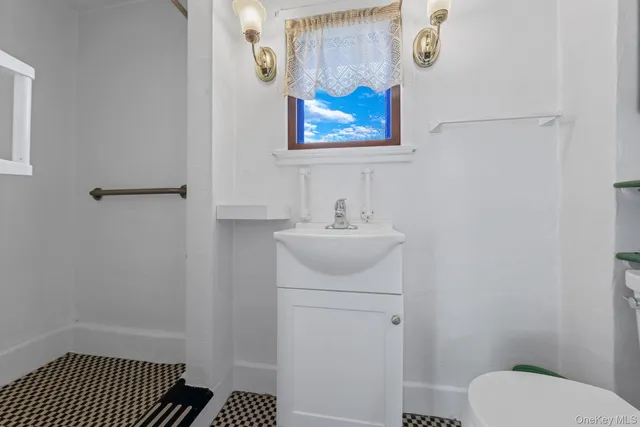 a bathroom with a sink toilet and vanity