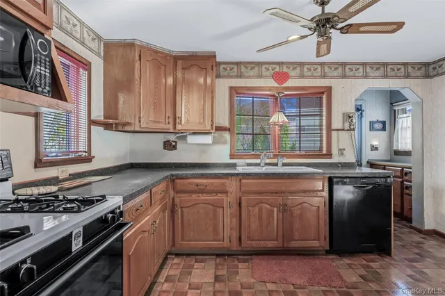 a kitchen with stainless steel appliances granite countertop a stove and a sink
