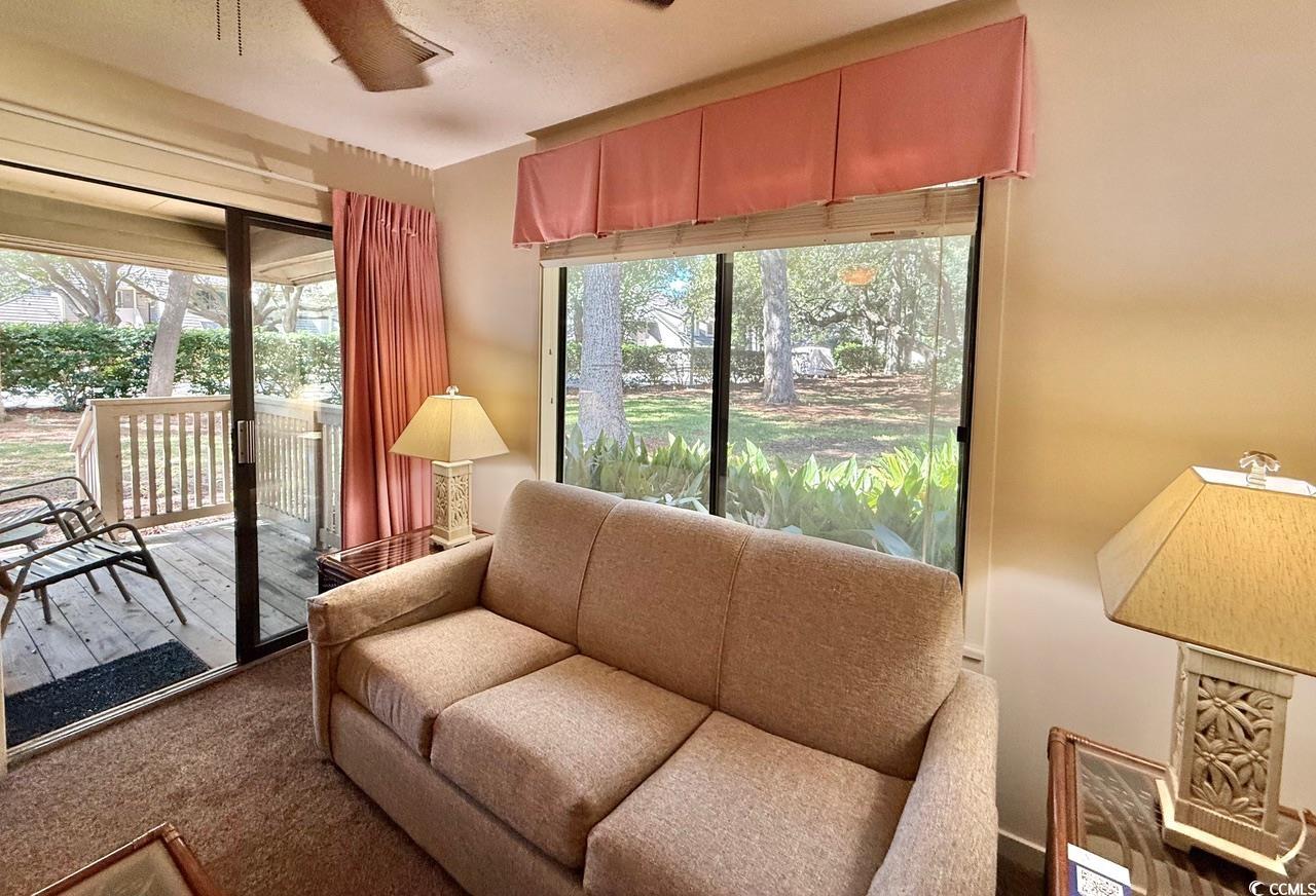 404 Melrose Place, Unit 21A Myrtle Beach, SC 29572 - Photo 10 of 30 Living room with ceiling fan and carpet floors