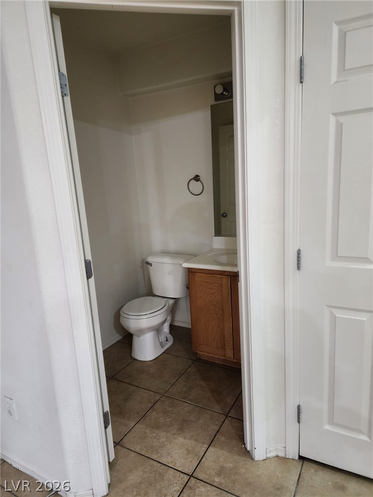 11901 Fairfax Ridge Street Las Vegas, NV 89183 - Photo 44 of 46 Half bath with vanity and tile patterned floors