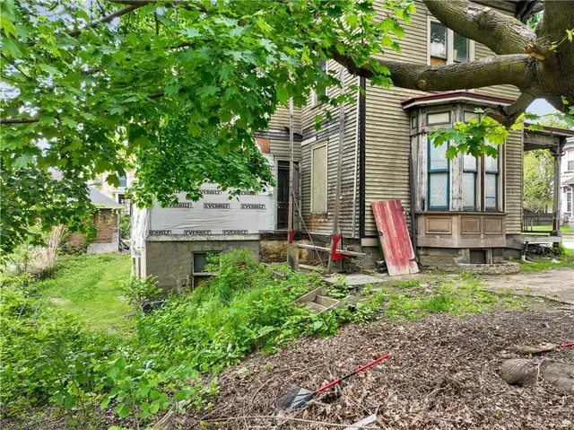 a view of a house with a backyard and a patio