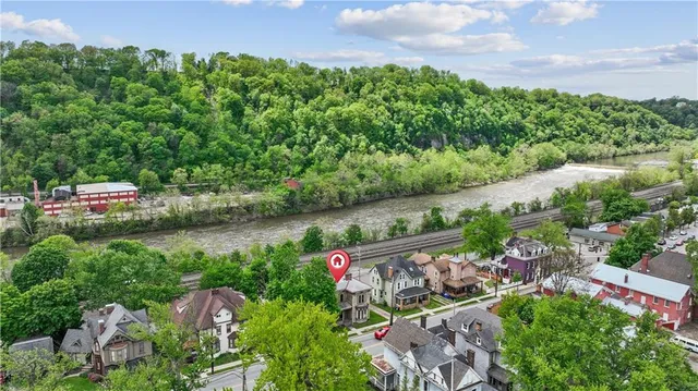 an aerial view of a house with a yard and lake view