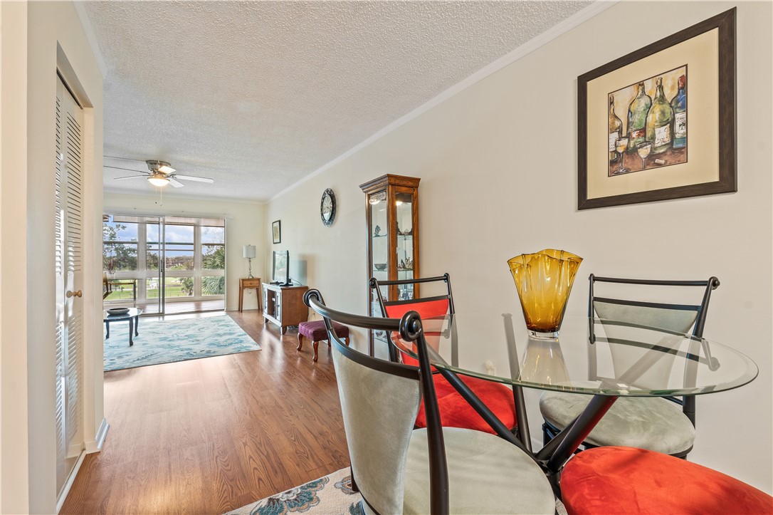275 Date Palm Road, Unit 403 Vero Beach, FL 32963 - Photo 11 of 35 a view of gym equipment with wooden floor and windows