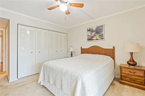a spacious bedroom with a bed and a chandelier