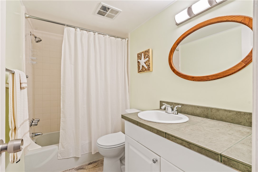 275 Date Palm Road, Unit 403 Vero Beach, FL 32963 - Photo 22 of 35 a bathroom with a sink a toilet and a mirror