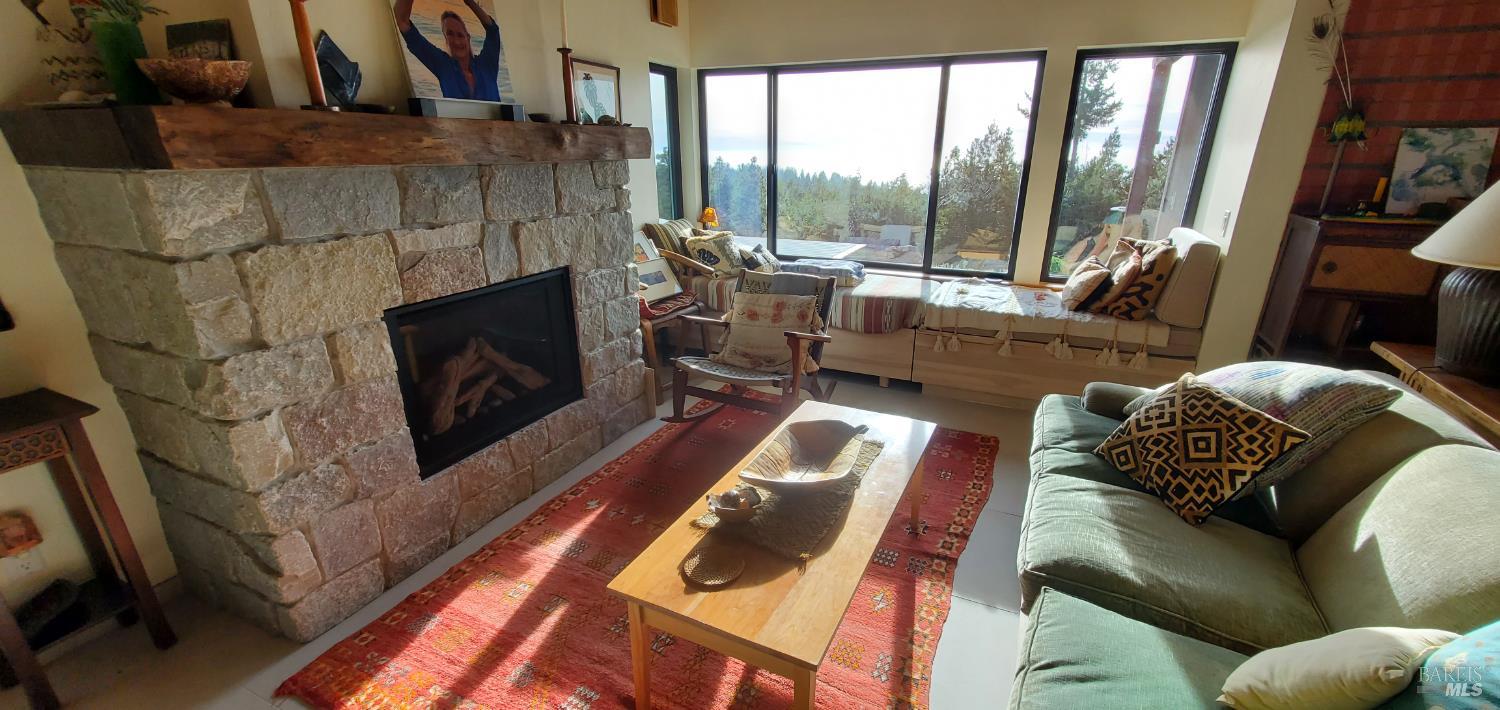 34478 Iversen Road Gualala, CA 95445 - Photo 6 of 43 Living room with gas fireplace, great window seat, and plenty of seating for reading, TV, and down time.