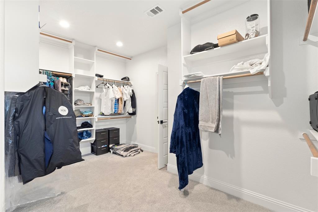 105 Clayton Crossing Springtown, TX 76082 - Photo 19 of 40 a view of walk in closet with clothes and shoes
