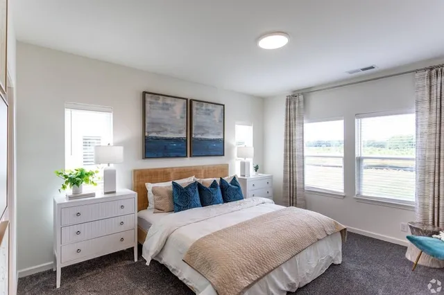 a bedroom with a bed and window with mirror