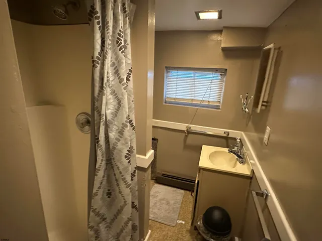 a walk in closet with wooden floor