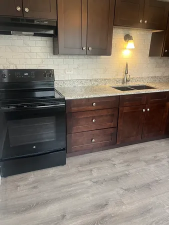 a kitchen with a stove and a sink