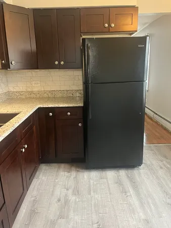 a kitchen with a refrigerator and cabinets