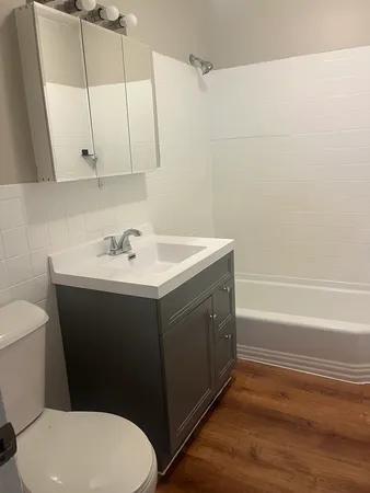 a bathroom with a sink toilet and tub