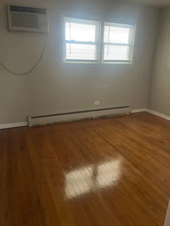 a view of a room with wooden floor and windows