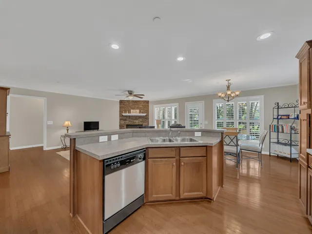 a kitchen that has a lot of cabinets in it and wooden floors
