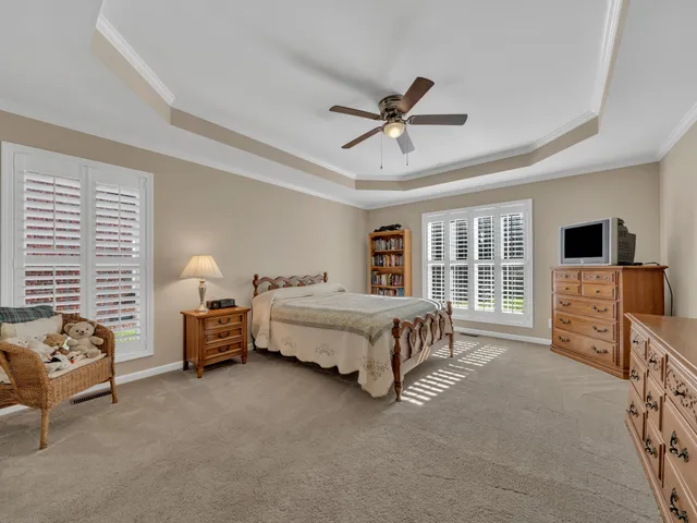 a bedroom with a bed chair and flat screen tv