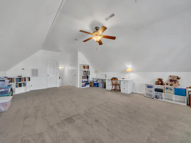 a view of a livingroom with furniture and a ceiling fan