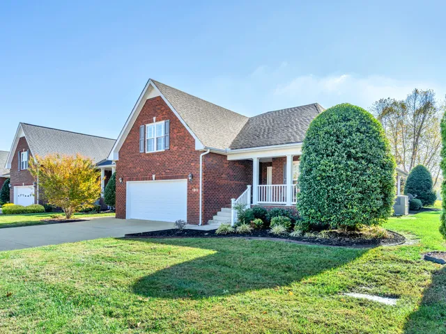 a front view of a house with a garden and plants