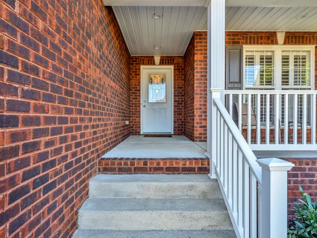a view of front door of house with stairs