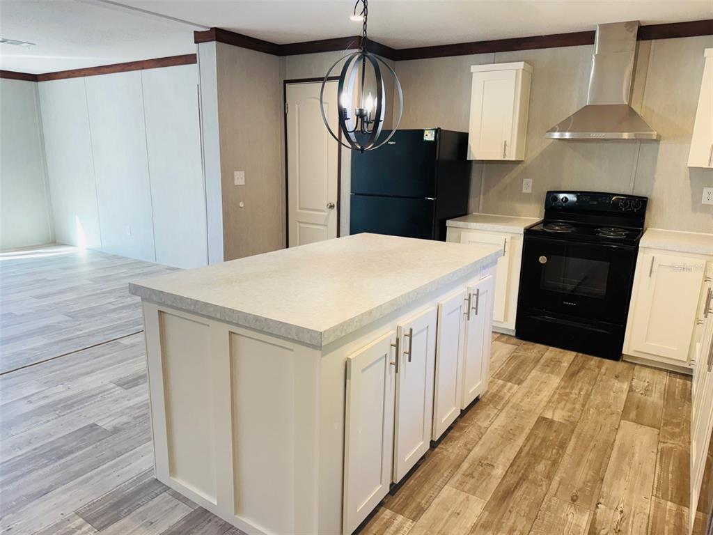 16226 41st Place Wellborn, FL 32094 - Photo 7 of 18 a kitchen with granite countertop white cabinets and refrigerator