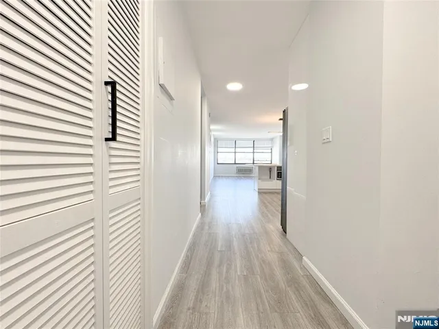 a view of a room with wooden floor