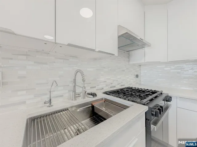a kitchen with a sink and cabinets