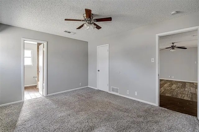 a view of a livingroom with a ceiling fan and entryway