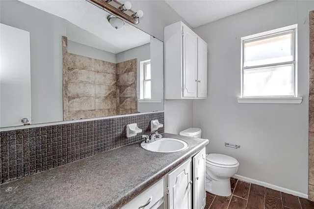 a bathroom with a sink toilet and shower