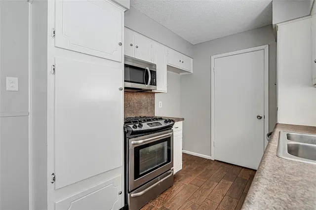 a kitchen with a stove and a microwave