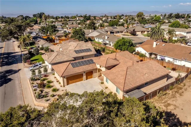 an aerial view of a house with a yard