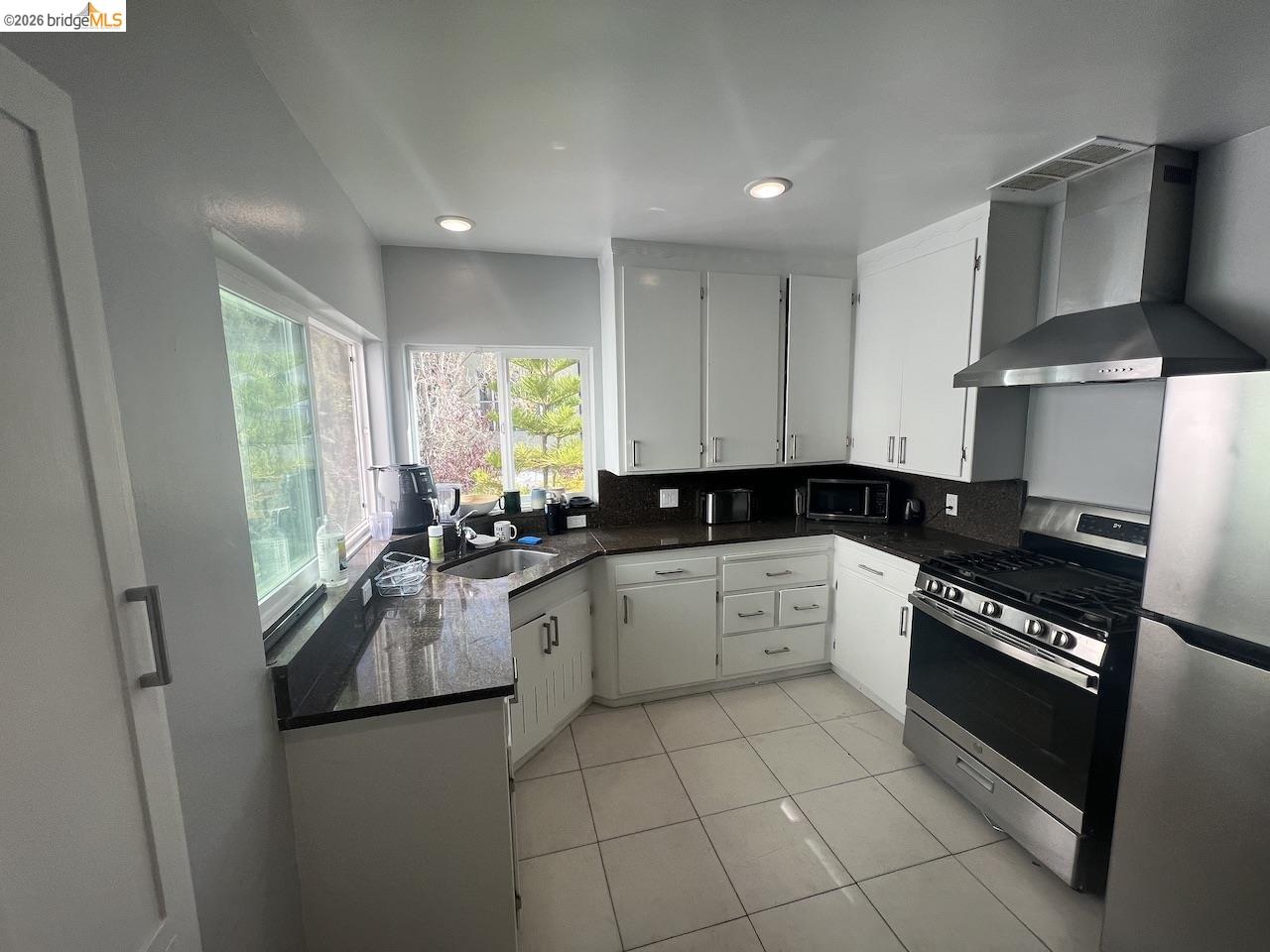 2554 Virginia Street Berkeley, CA 94709 - Photo 4 of 6 a kitchen with stainless steel appliances granite countertop a stove a sink and a refrigerator