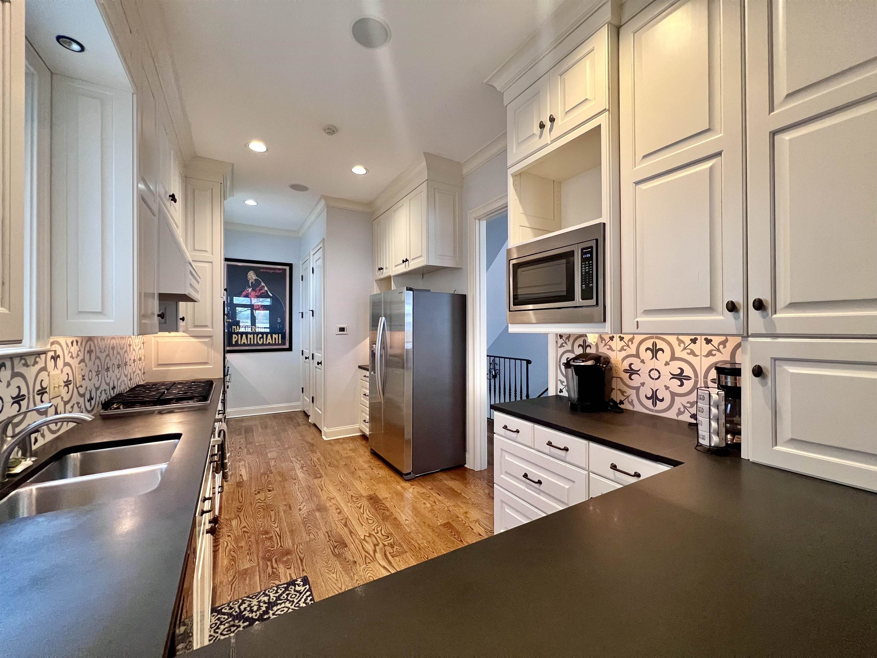 481 Tennessee Street Memphis, TN 38103 - Photo 2 of 40 a kitchen with stainless steel appliances granite countertop a refrigerator and a stove top oven