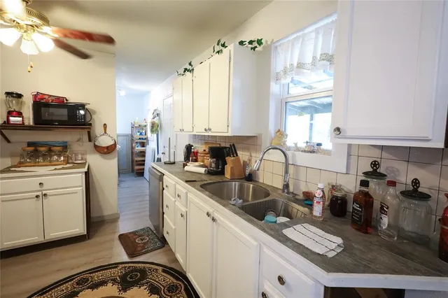 a kitchen with stainless steel appliances a stove refrigerator sink and cabinets