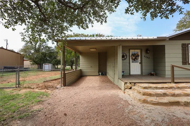 a view of a house with backyard and garage