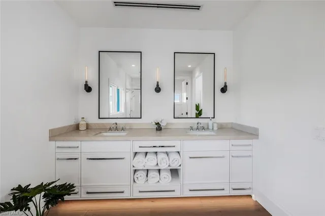a view of a house with a yard and potted plants