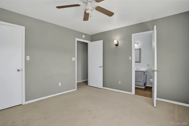 a view of an empty room and a ceiling fan