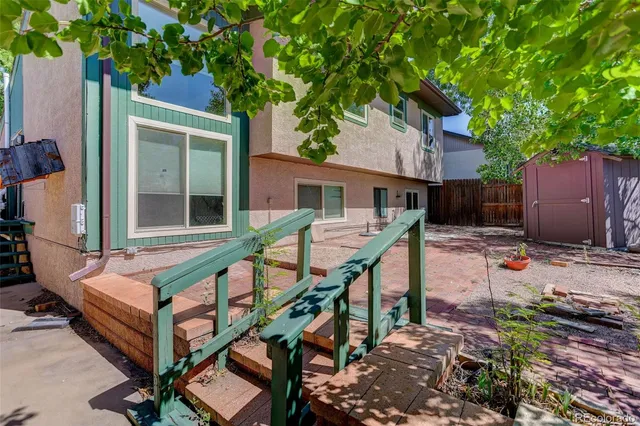 a view of house with backyard and trees