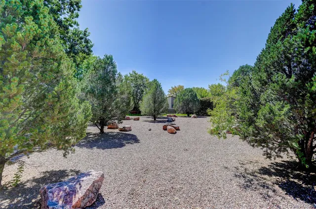 a view of a backyard with sitting area