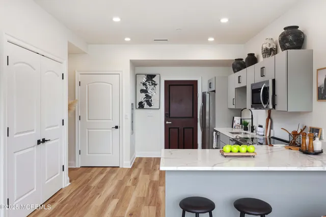 a kitchen with stainless steel appliances a refrigerator sink and wooden cabinets