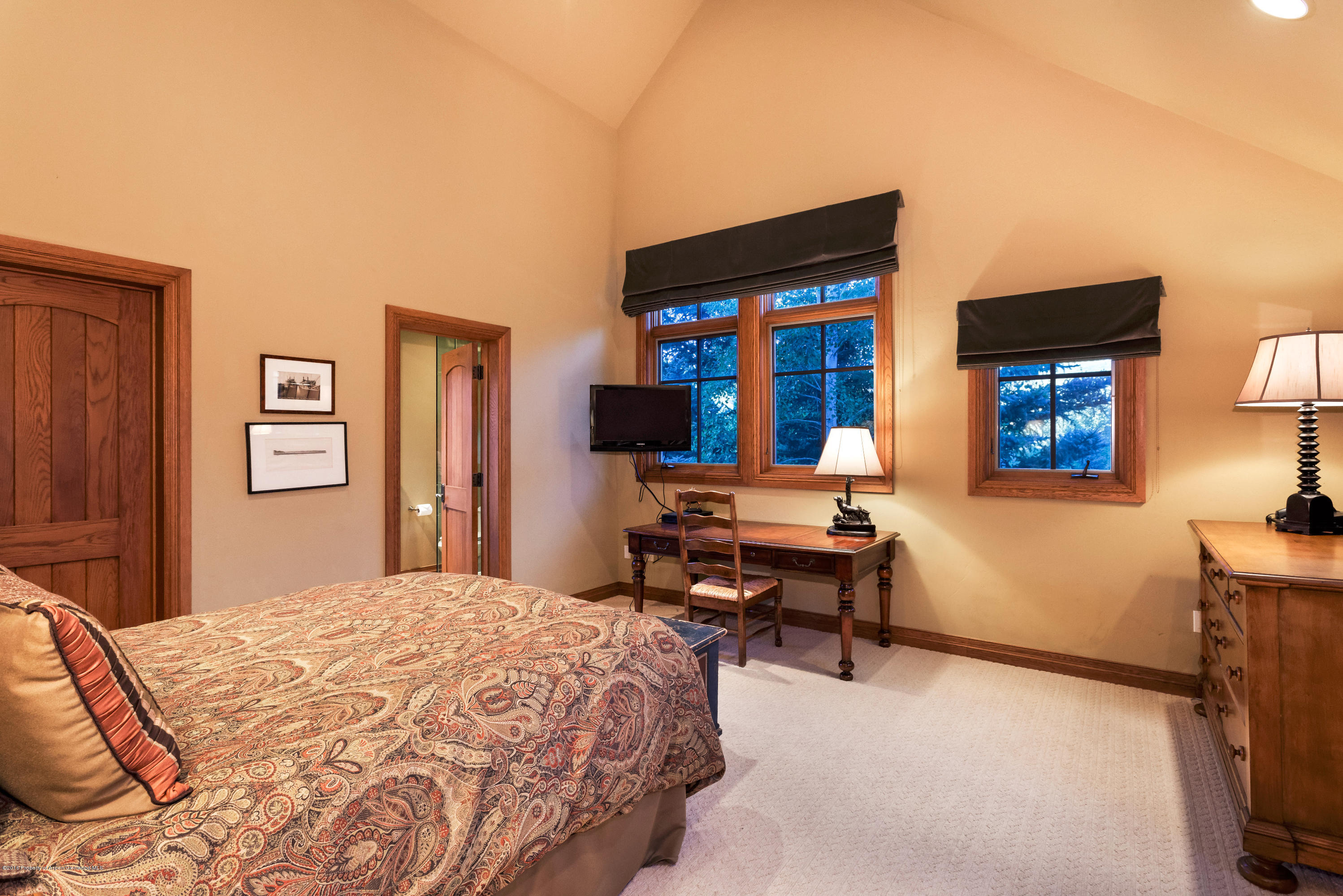 1205 Tiehack Road Aspen, CO 81611 - Photo 14 of 23 a bedroom with a bed table and two windows