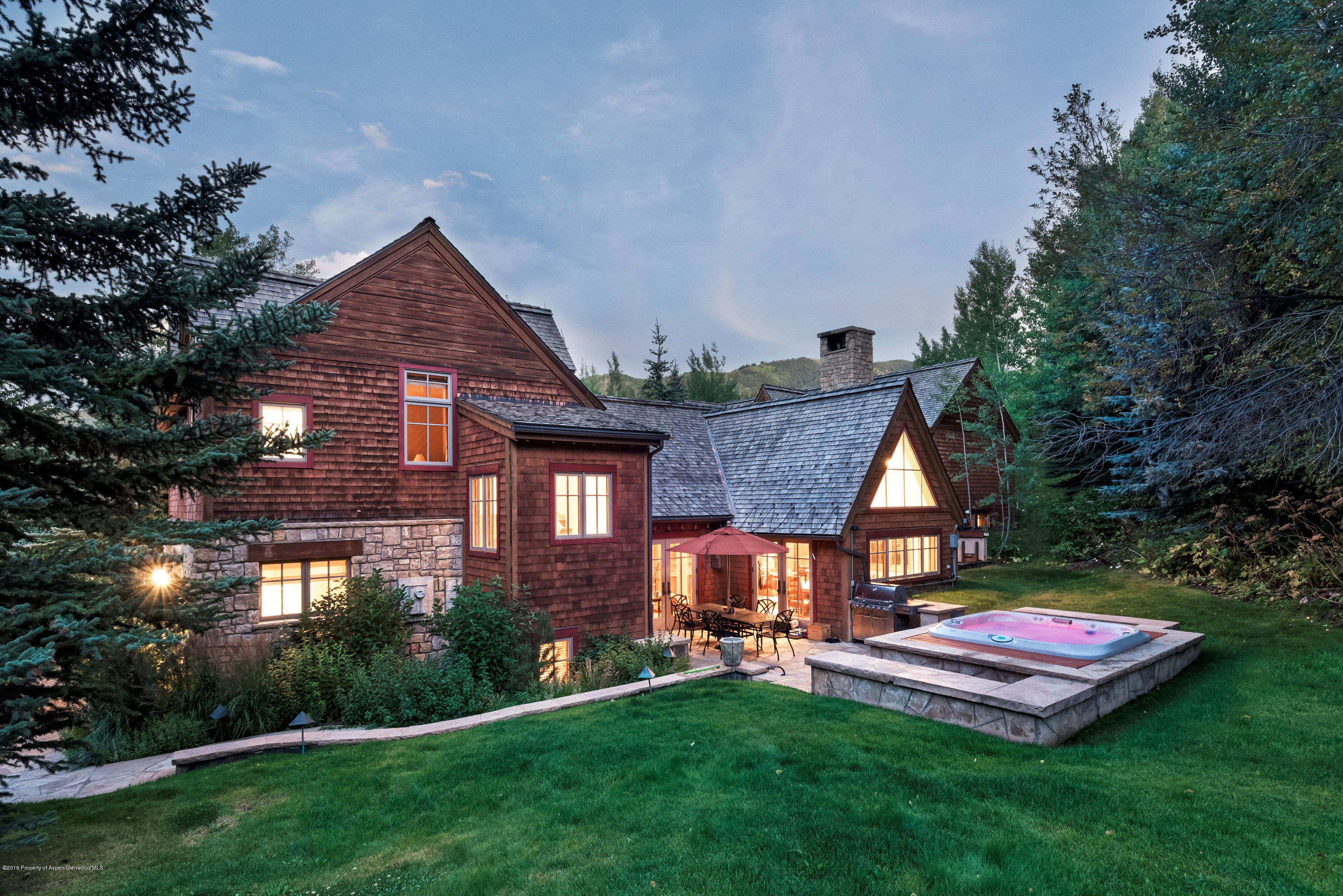 1205 Tiehack Road Aspen, CO 81611 - Photo 23 of 23 a front view of a house with a yard table and chairs
