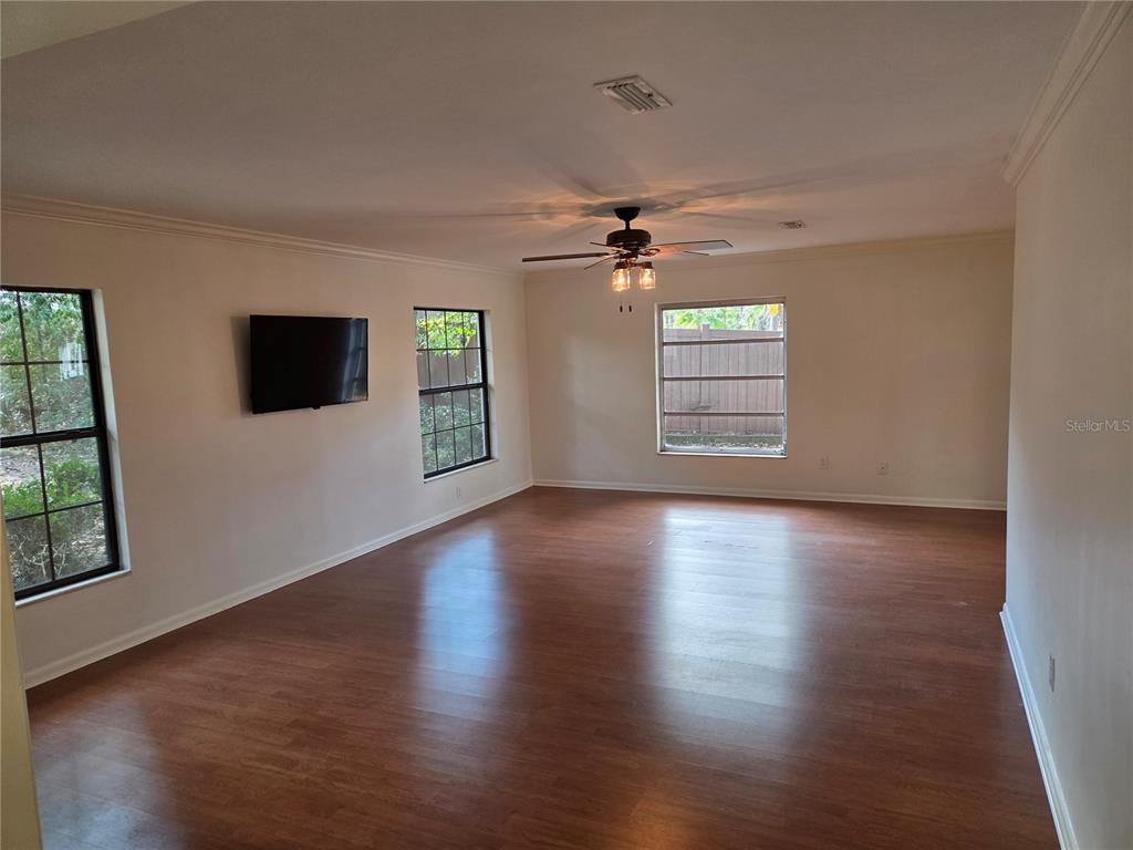 2901 Southwest 4 Court Gainesville, FL 32601 - Photo 20 of 58 a view of a livingroom with wooden floor a ceiling fan and a window