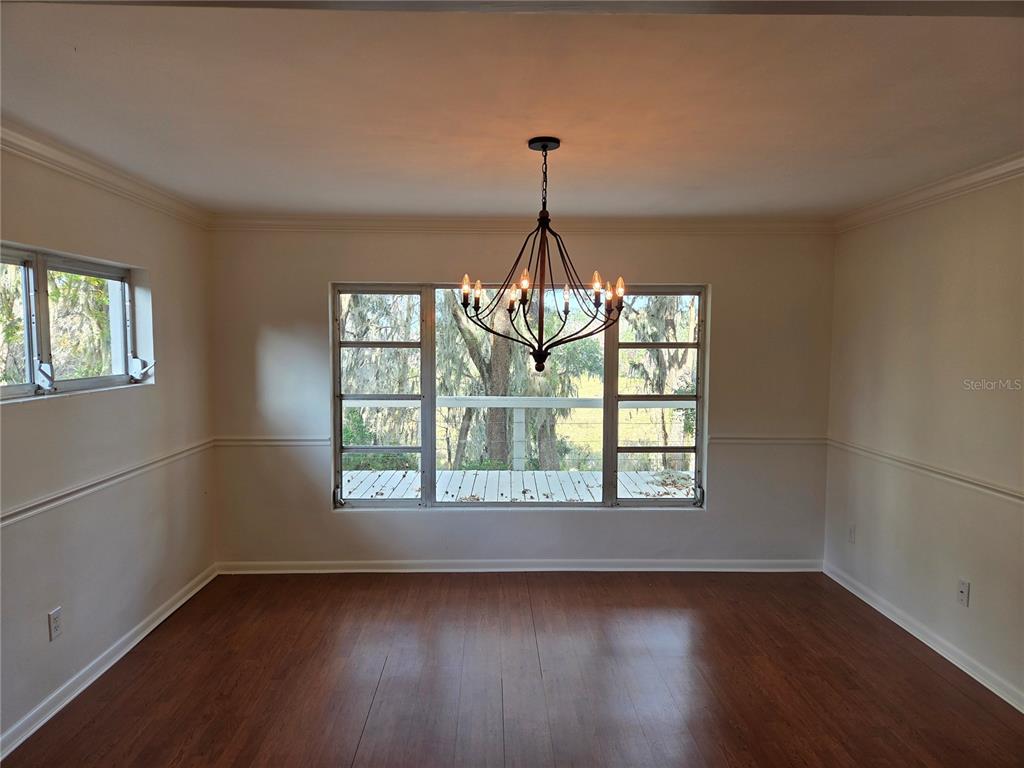 2901 Southwest 4 Court Gainesville, FL 32601 - Photo 22 of 58 a view of an empty room with wooden floor and a window