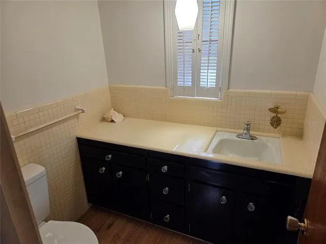 a kitchen with white cabinets and appliances