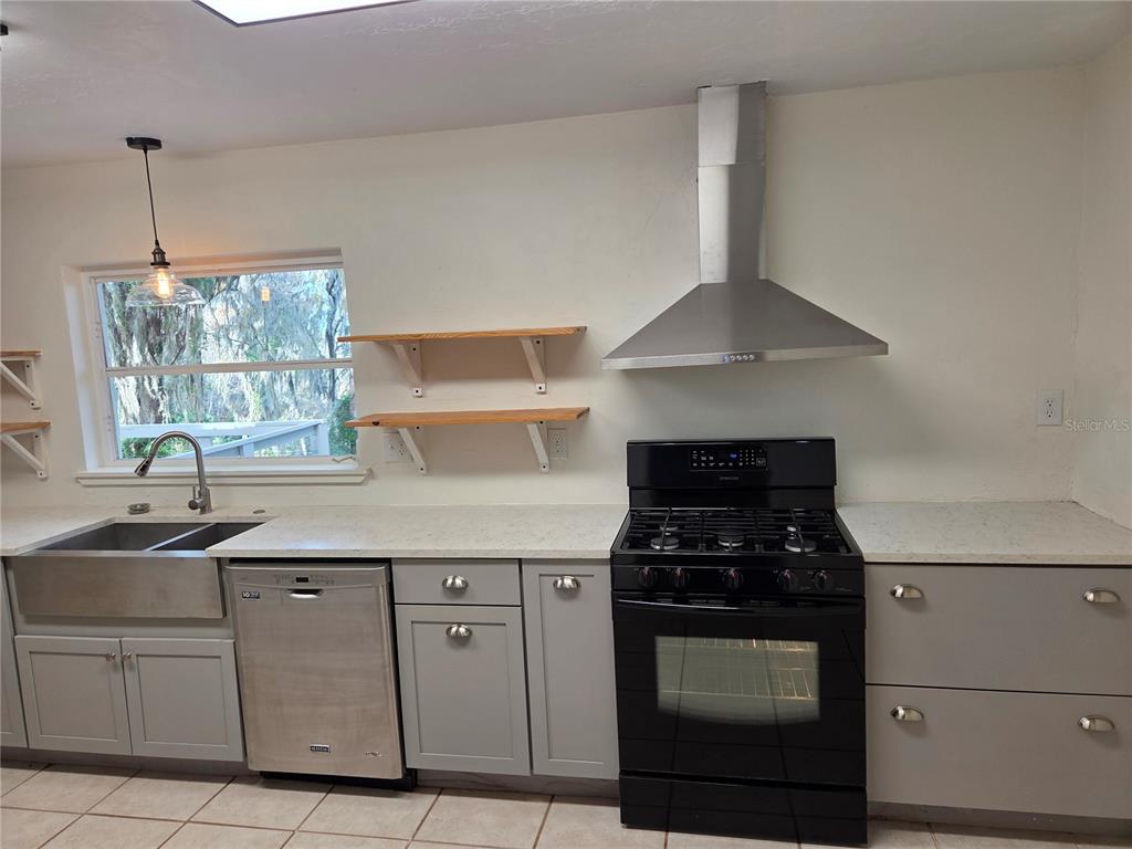 2901 Southwest 4 Court Gainesville, FL 32601 - Photo 26 of 58 a kitchen with white cabinets and appliances