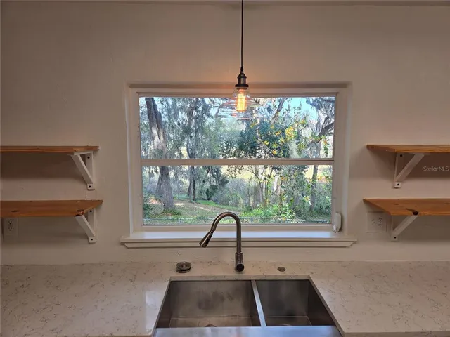 a kitchen with a sink and large window