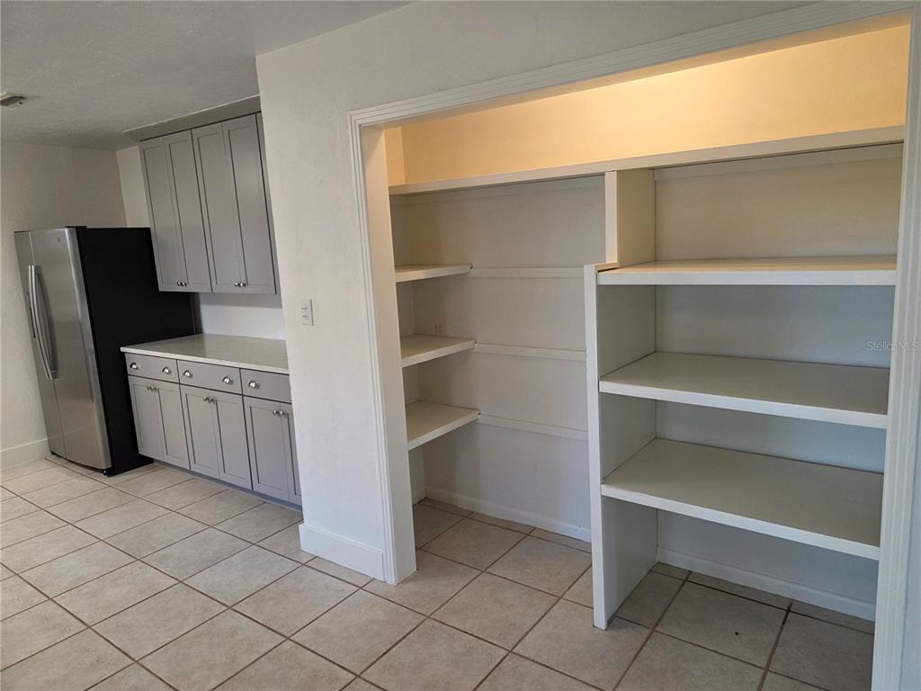 2901 Southwest 4 Court Gainesville, FL 32601 - Photo 33 of 58 a kitchen with a refrigerator and white cabinets