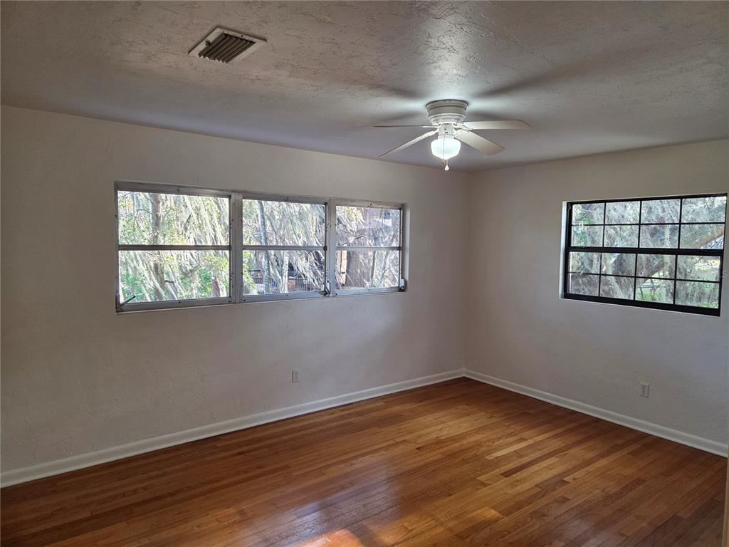 2901 Southwest 4 Court Gainesville, FL 32601 - Photo 57 of 58 a view of an empty room with wooden floor and a window