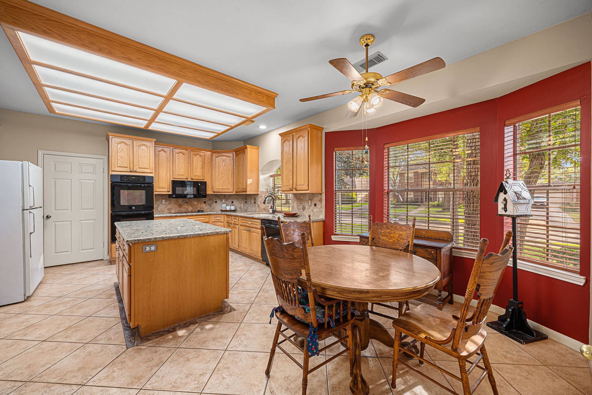 1102 Wood Fern Drive Sugar Land, TX 77479 - Photo 20 of 43 a kitchen with a dining table chairs stainless steel appliances and cabinets